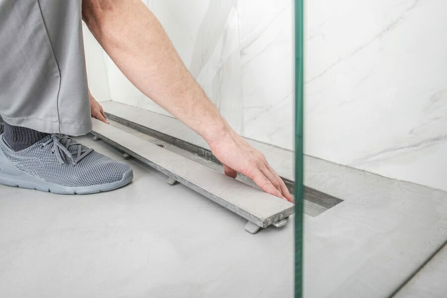Linear shower drain being professionally installed